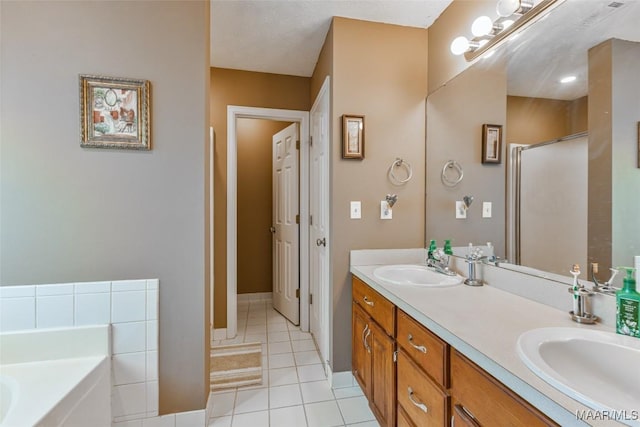 bathroom with a stall shower, a bath, tile patterned flooring, and a sink