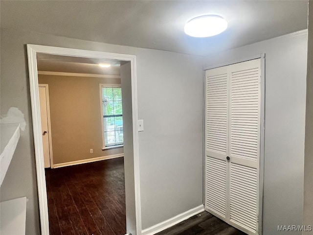 hall with dark wood-type flooring and baseboards