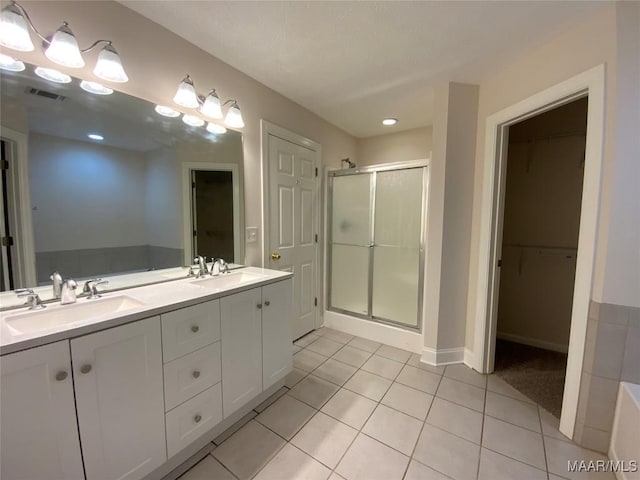 1939 Cedar Ridge Loop, Prattville, AL 36067 - full bath featuring a shower stall, tile patterned flooring, double vanity, a walk in closet, and baseboards