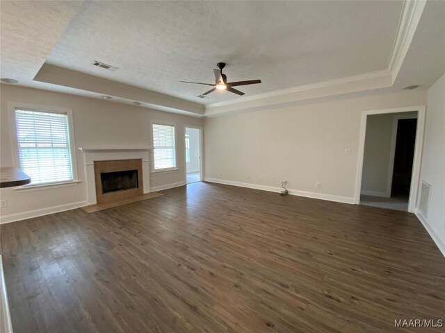 1939 Cedar Ridge Loop, Prattville, AL 36067 - unfurnished living room featuring a raised ceiling, a ceiling fan, dark wood-style floors, ornamental molding, and a textured ceiling