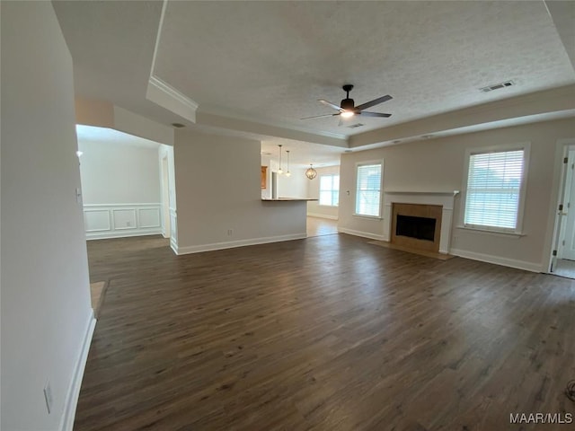 1939 Cedar Ridge Loop, Prattville, AL 36067 - unfurnished living room with a ceiling fan, dark wood-style floors, a tile fireplace, ornamental molding, and a textured ceiling