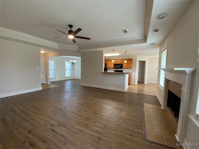 1939 Cedar Ridge Loop, Prattville, AL 36067 - unfurnished living room featuring a chandelier, a fireplace, ceiling fan, wood finished floors, and crown molding