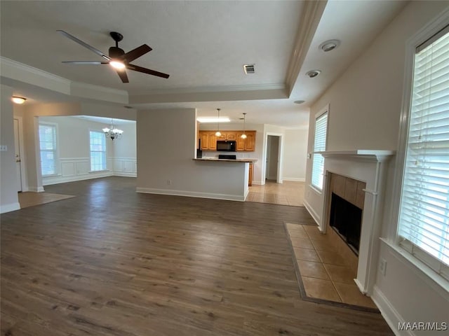 1939 Cedar Ridge Loop, Prattville, AL 36067 - unfurnished living room with ornamental molding, a chandelier, a tile fireplace, dark wood-type flooring, and ceiling fan