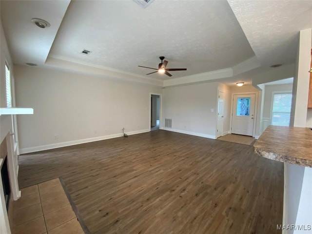 1939 Cedar Ridge Loop, Prattville, AL 36067 - unfurnished living room with a tray ceiling, ceiling fan, dark wood-style floors, baseboards, and a textured ceiling