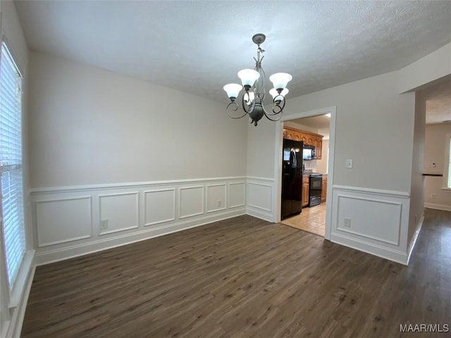 1939 Cedar Ridge Loop, Prattville, AL 36067 - unfurnished dining area with a chandelier, wood finished floors, wainscoting, and a decorative wall