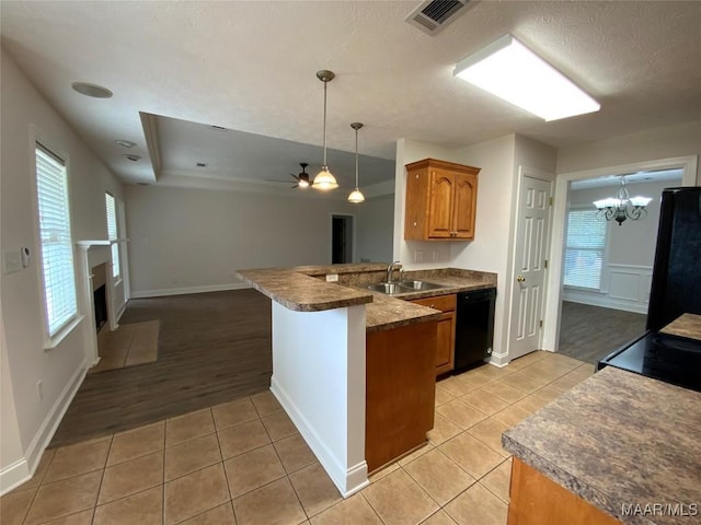 1939 Cedar Ridge Loop, Prattville, AL 36067 - kitchen featuring black appliances, a peninsula, light tile patterned flooring, brown cabinetry, and open floor plan