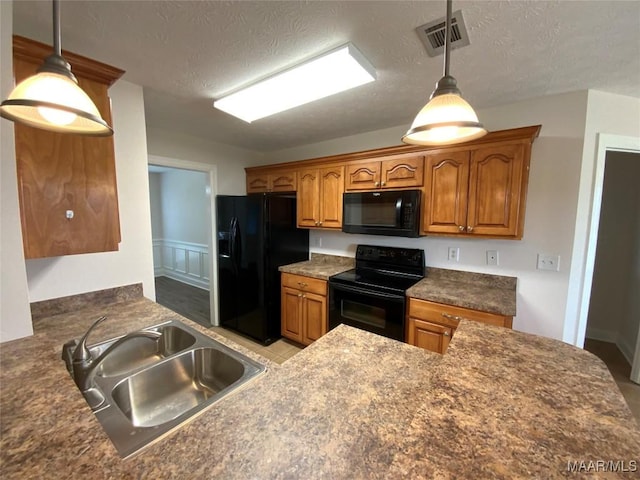 1939 Cedar Ridge Loop, Prattville, AL 36067 - kitchen with black appliances, a sink, dark countertops, brown cabinets, and a textured ceiling