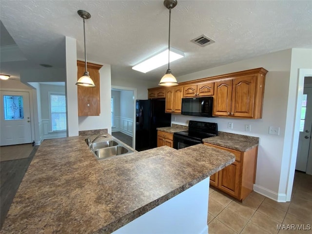 1939 Cedar Ridge Loop, Prattville, AL 36067 - kitchen with black appliances, a sink, brown cabinetry, dark countertops, and a peninsula