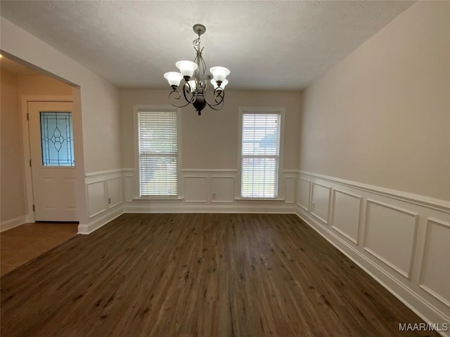 1939 Cedar Ridge Loop, Prattville, AL 36067 - unfurnished dining area featuring a chandelier, dark wood-style flooring, wainscoting, and a decorative wall