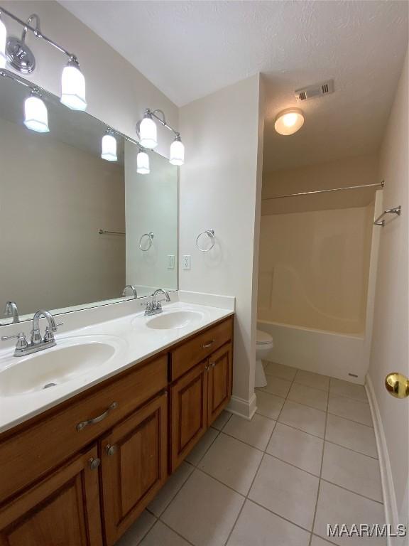 1939 Cedar Ridge Loop, Prattville, AL 36067 - bathroom with tile patterned flooring, double vanity, toilet,  shower combination, and baseboards