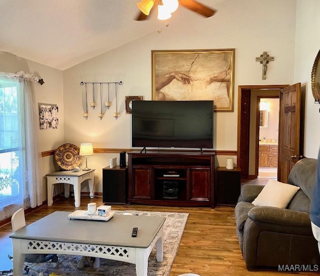 living room with vaulted ceiling, wood finished floors, and ceiling fan