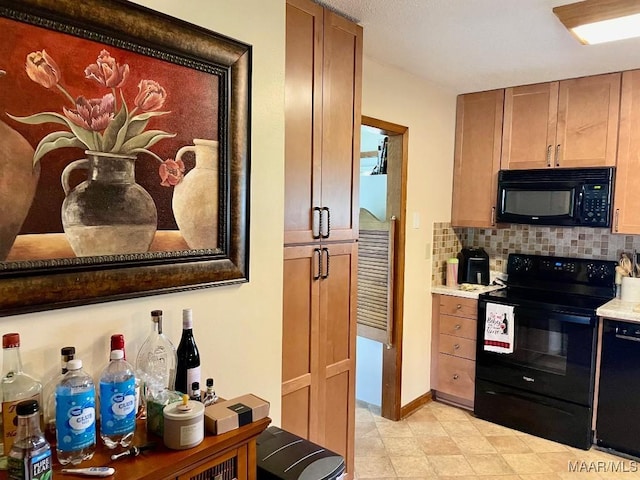 kitchen featuring black appliances, backsplash, light countertops, and baseboards