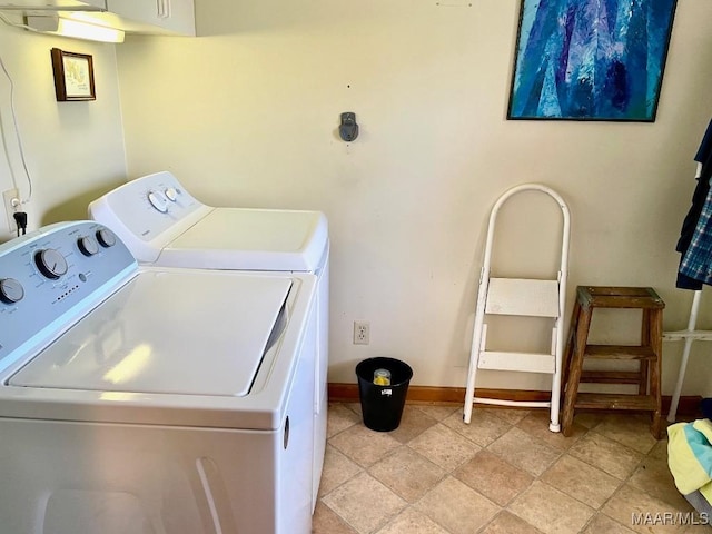 washroom with washer and clothes dryer and baseboards
