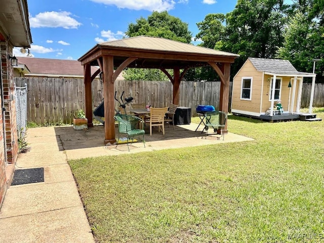 view of yard featuring a gazebo, an outdoor structure, and a patio area