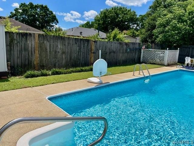 view of pool with a fenced backyard and a patio