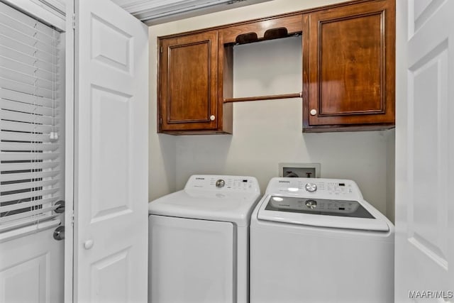 laundry area featuring cabinet space and washing machine and clothes dryer