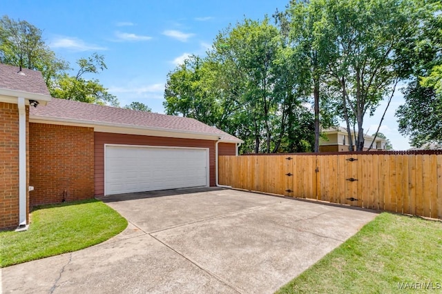 garage with a gate and fence
