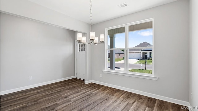 unfurnished dining area with an inviting chandelier, baseboards, dark wood-style floors, and visible vents