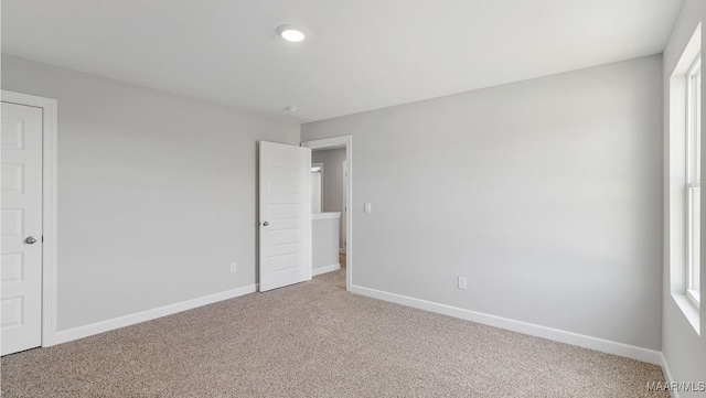 unfurnished bedroom with carpet and baseboards