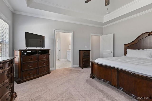 bedroom with connected bathroom, light carpet, a raised ceiling, and ornamental molding