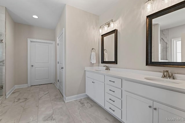 full bathroom featuring a sink, baseboards, a shower stall, and marble finish floor
