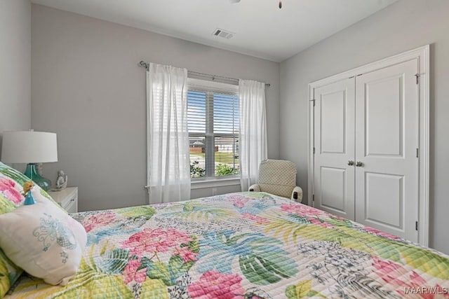 bedroom featuring a closet, visible vents, and ceiling fan