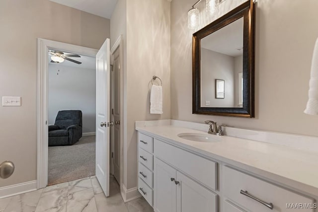 bathroom featuring vanity, baseboards, a ceiling fan, and marble finish floor