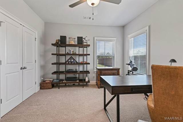 home office with visible vents, ceiling fan, and carpet floors