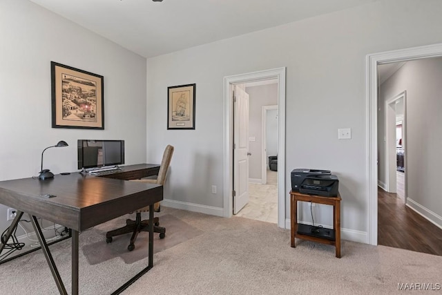office space featuring carpet flooring and baseboards