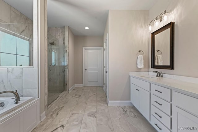 bathroom with marble finish floor, vanity, a shower stall, baseboards, and a bath