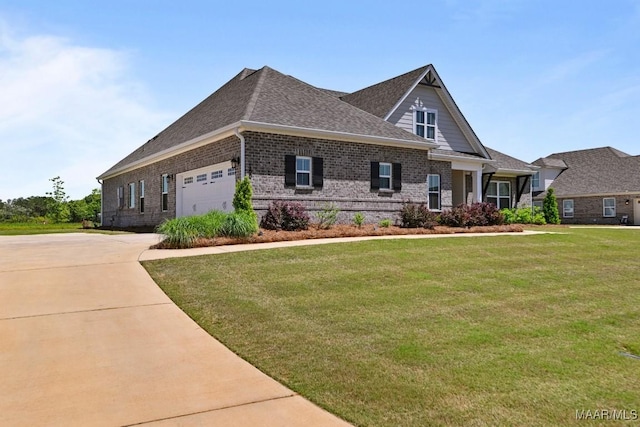craftsman inspired home with an attached garage, a shingled roof, brick siding, and a front yard