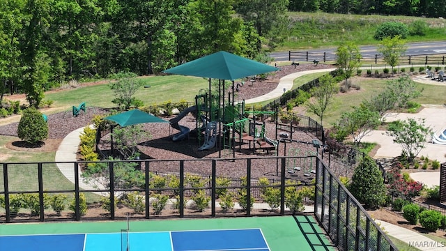 exterior space with a lawn, playground community, and fence
