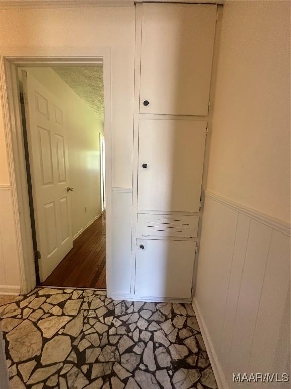 5545 E Shades Valley Dr, Montgomery, AL 36108 - hall with a wainscoted wall and stone finish floor