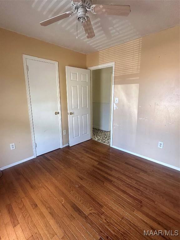 5545 E Shades Valley Dr, Montgomery, AL 36108 - unfurnished bedroom featuring baseboards, hardwood / wood-style floors, and a ceiling fan