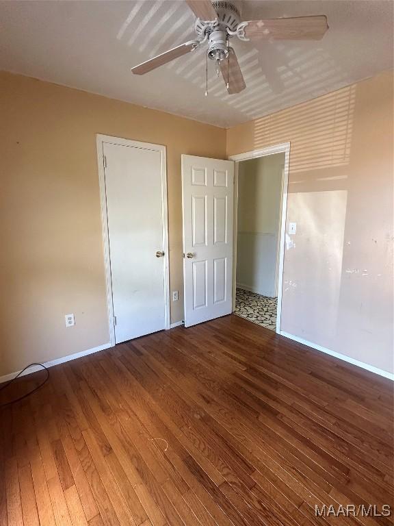 5545 E Shades Valley Dr, Montgomery, AL 36108 - unfurnished bedroom featuring baseboards, hardwood / wood-style floors, and ceiling fan