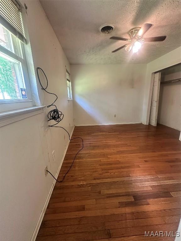 5545 E Shades Valley Dr, Montgomery, AL 36108 - unfurnished bedroom featuring ceiling fan, a textured ceiling, visible vents, and wood finished floors