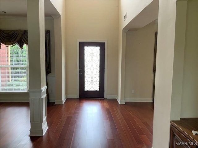 entryway with baseboards, dark wood-style flooring, and ornamental molding