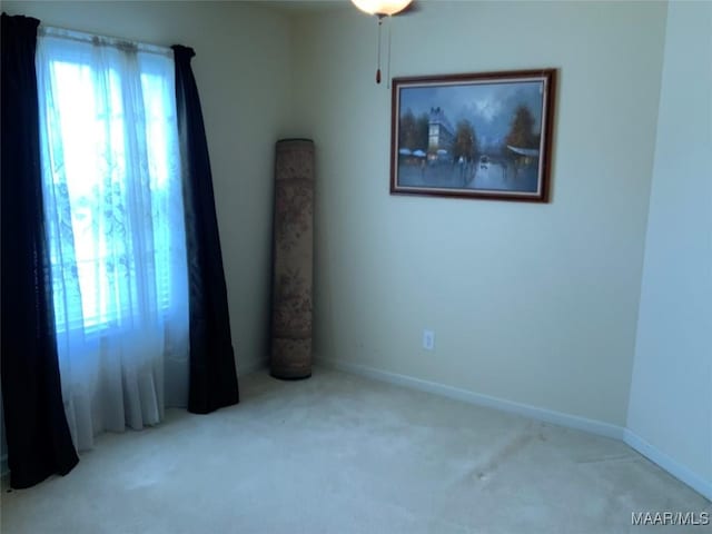 empty room with carpet and baseboards