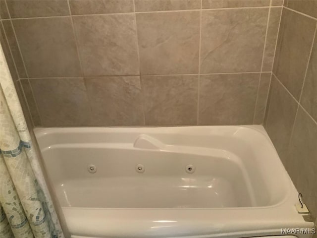 full bath featuring a tub with jets