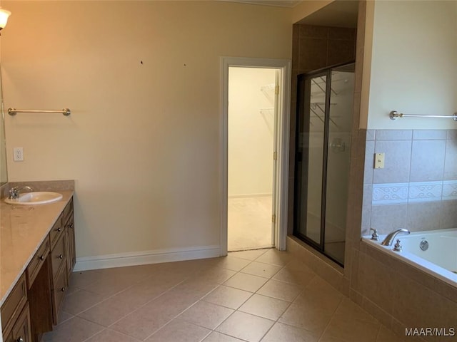 bathroom with tile patterned floors, vanity, a shower stall, and a garden tub