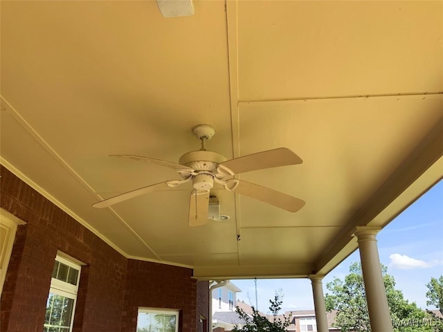 exterior details featuring a ceiling fan and ornate columns