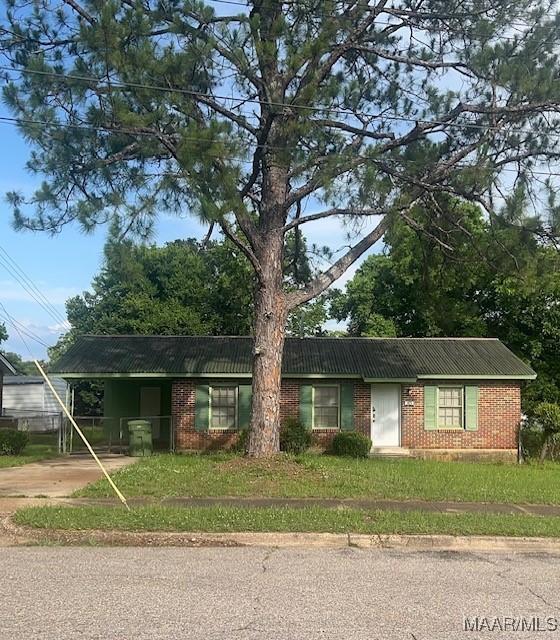 185 Conley Cir, Montgomery, AL 36110 - single story home with metal roof, driveway, brick siding, and a carport