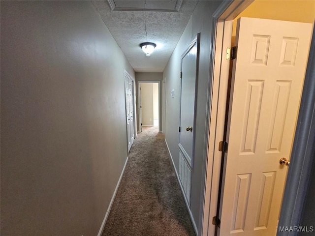 1946 Regent Rd, Prattville, AL 36066 - corridor featuring baseboards, dark colored carpet, attic access, and a textured ceiling