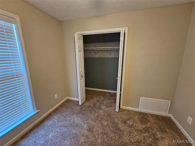 1946 Regent Rd, Prattville, AL 36066 - unfurnished bedroom with a closet, carpet floors, a textured ceiling, visible vents, and baseboards