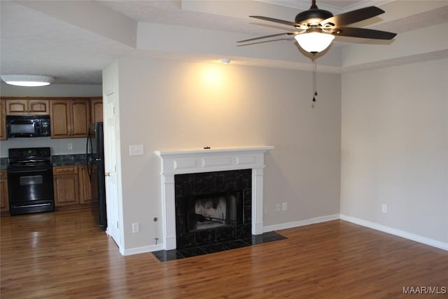 1946 Regent Rd, Prattville, AL 36066 - unfurnished living room with a ceiling fan, dark wood-style flooring, baseboards, and a fireplace