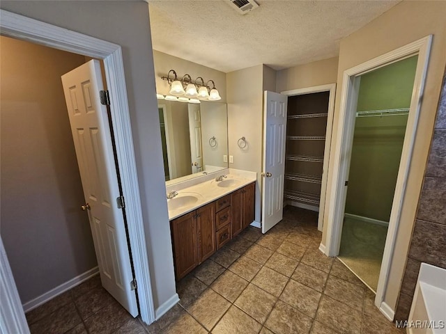 1946 Regent Rd, Prattville, AL 36066 - bathroom featuring a textured ceiling, visible vents, baseboards, and a sink