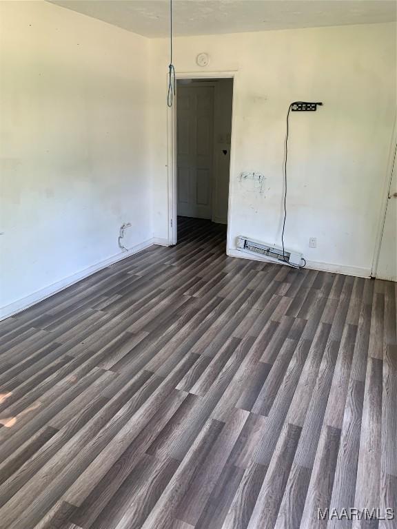 341 Chisholm St, Montgomery, AL 36110 - empty room with dark wood-style floors and baseboards
