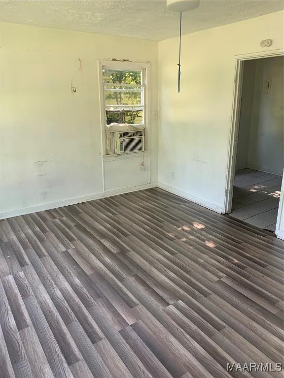 341 Chisholm St, Montgomery, AL 36110 - unfurnished room with wood finished floors, baseboards, a textured ceiling, and cooling unit