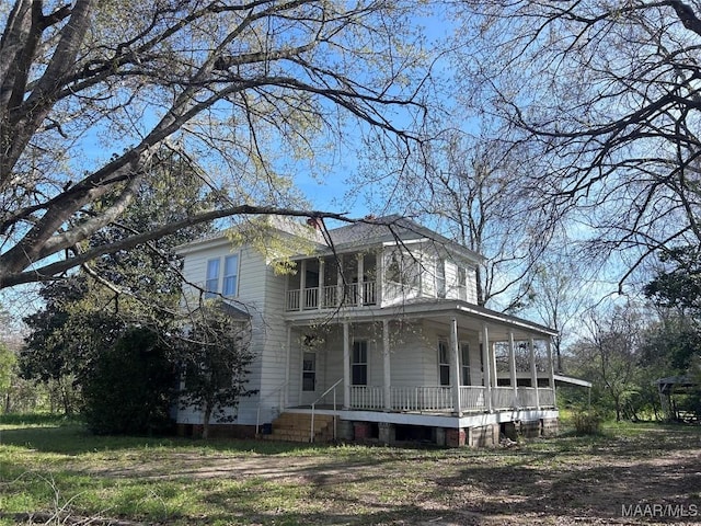 view of home's exterior with a porch and a balcony