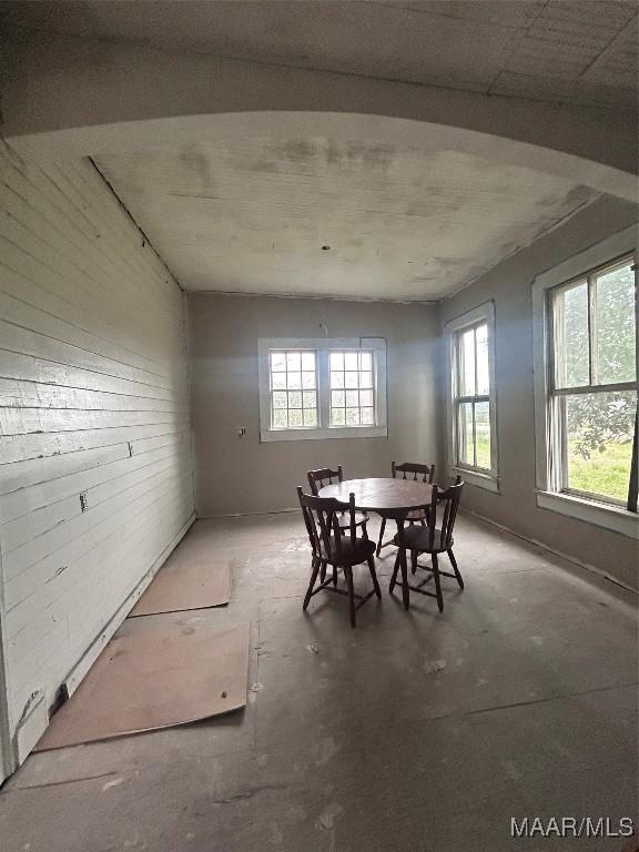 dining space featuring unfinished concrete flooring